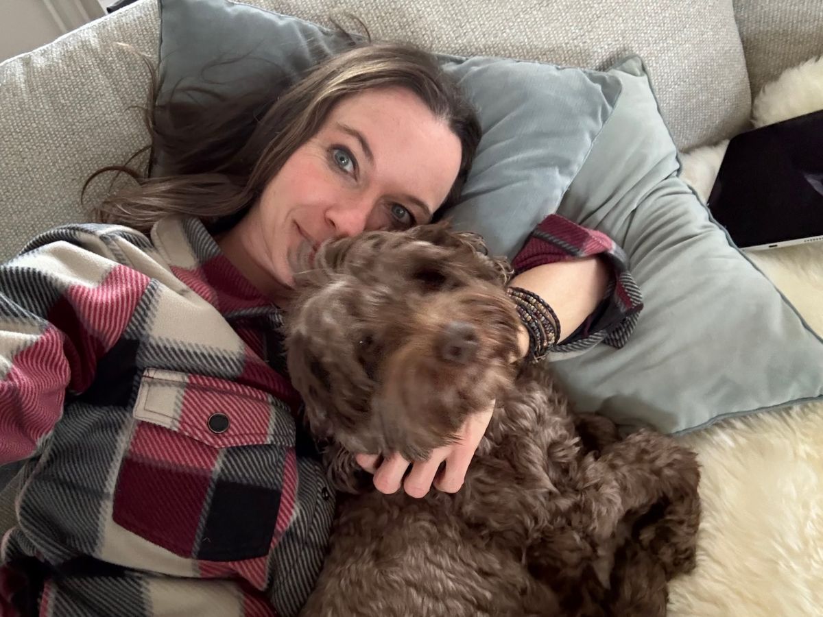 Michelle relaxing on the couch with Cherry | Spring Valley Australian Labradoodles